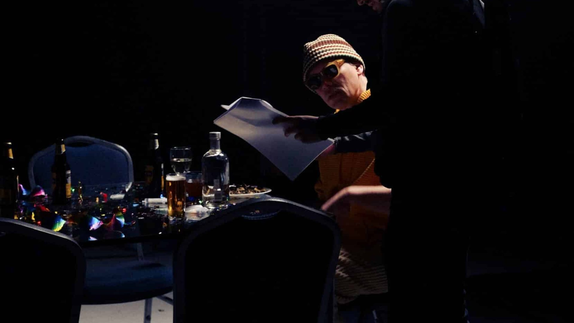 Two people collaborating on a creative video project in a dark studio.
