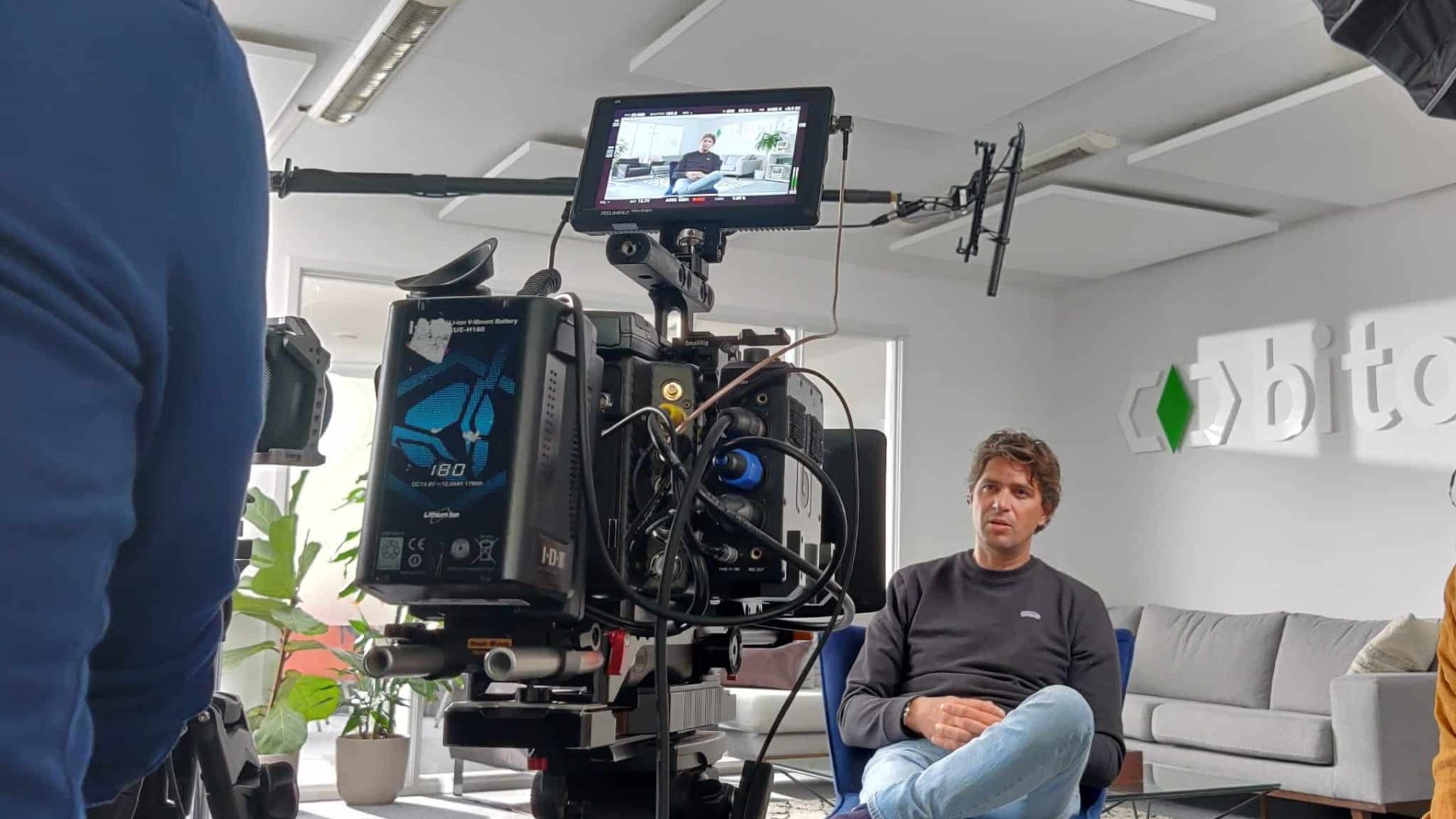 Behind-the-scenes of a video shoot in a modern office setting.