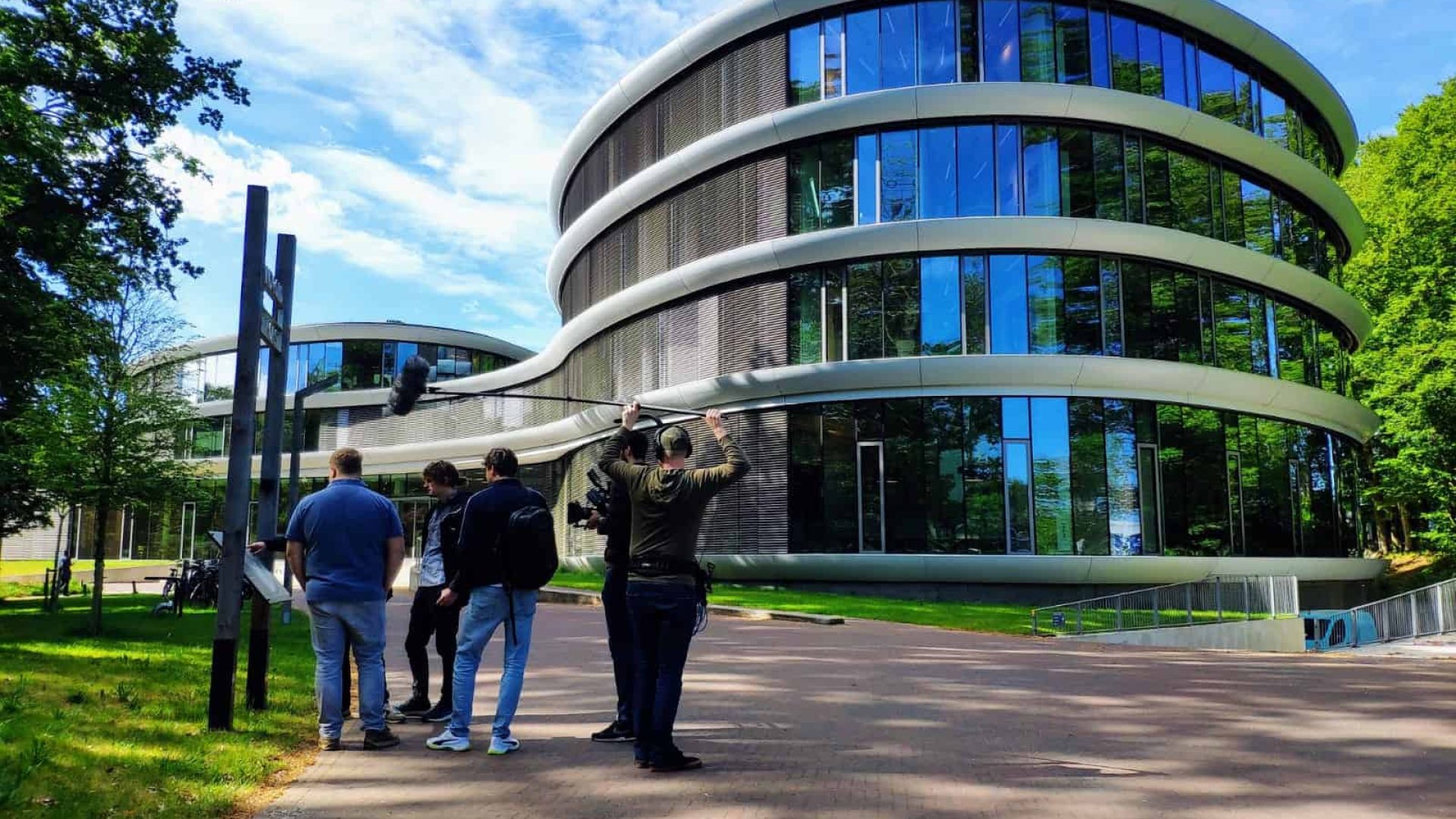 Contemporary office building with curved glass facade and sleek design.