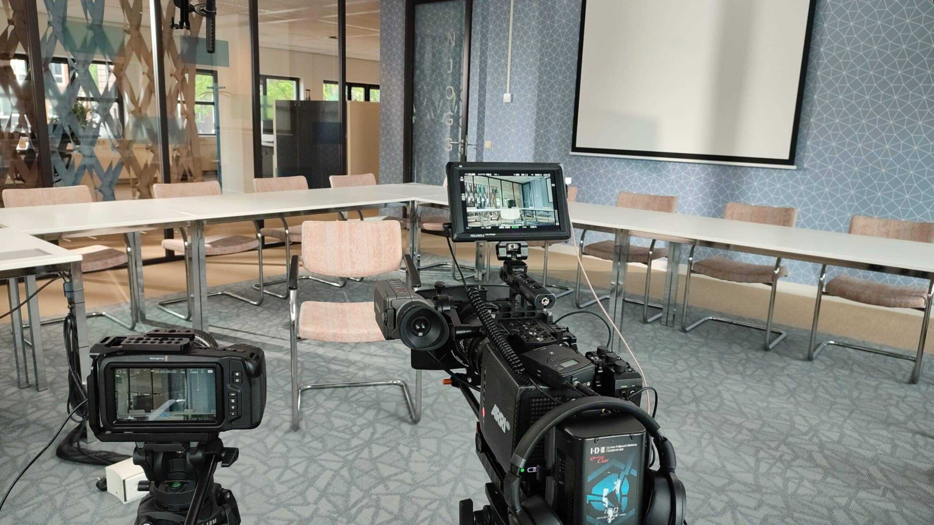 Video production camera setup in a modern conference room for professional video creation.