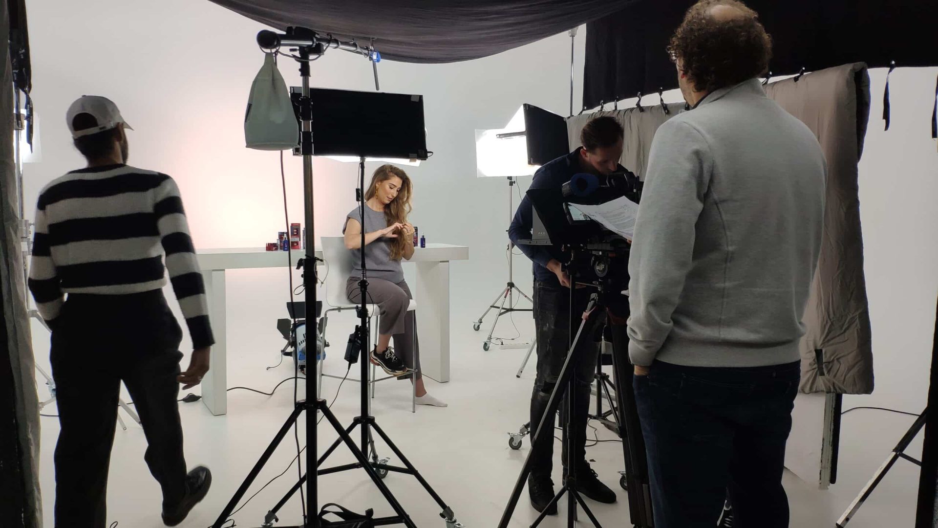 Behind-the-scenes of a professional video shoot in a studio setting.