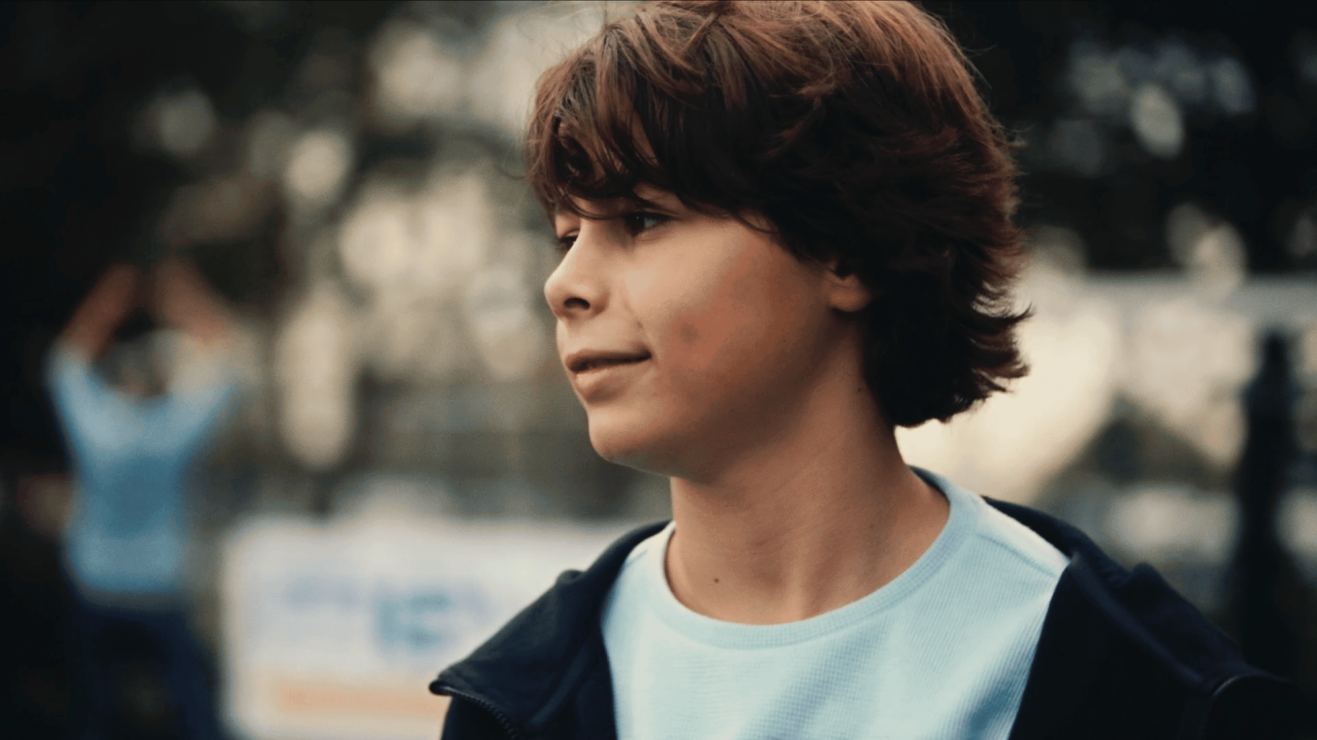 Young man with brown hair outdoors, representing creative video agency services.