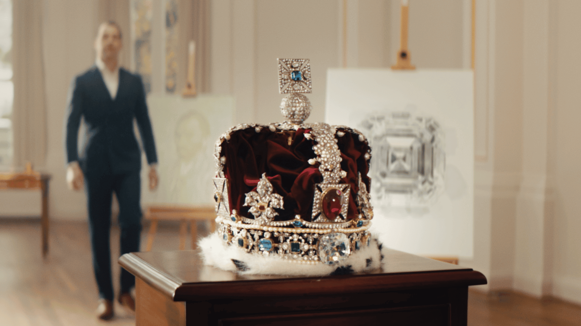 Elegant royal crown displayed in an art gallery setting.