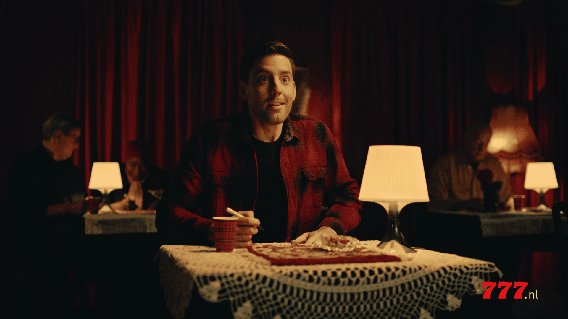 An image of a man smiling at a table during a creative meeting at Waves Video Agency.