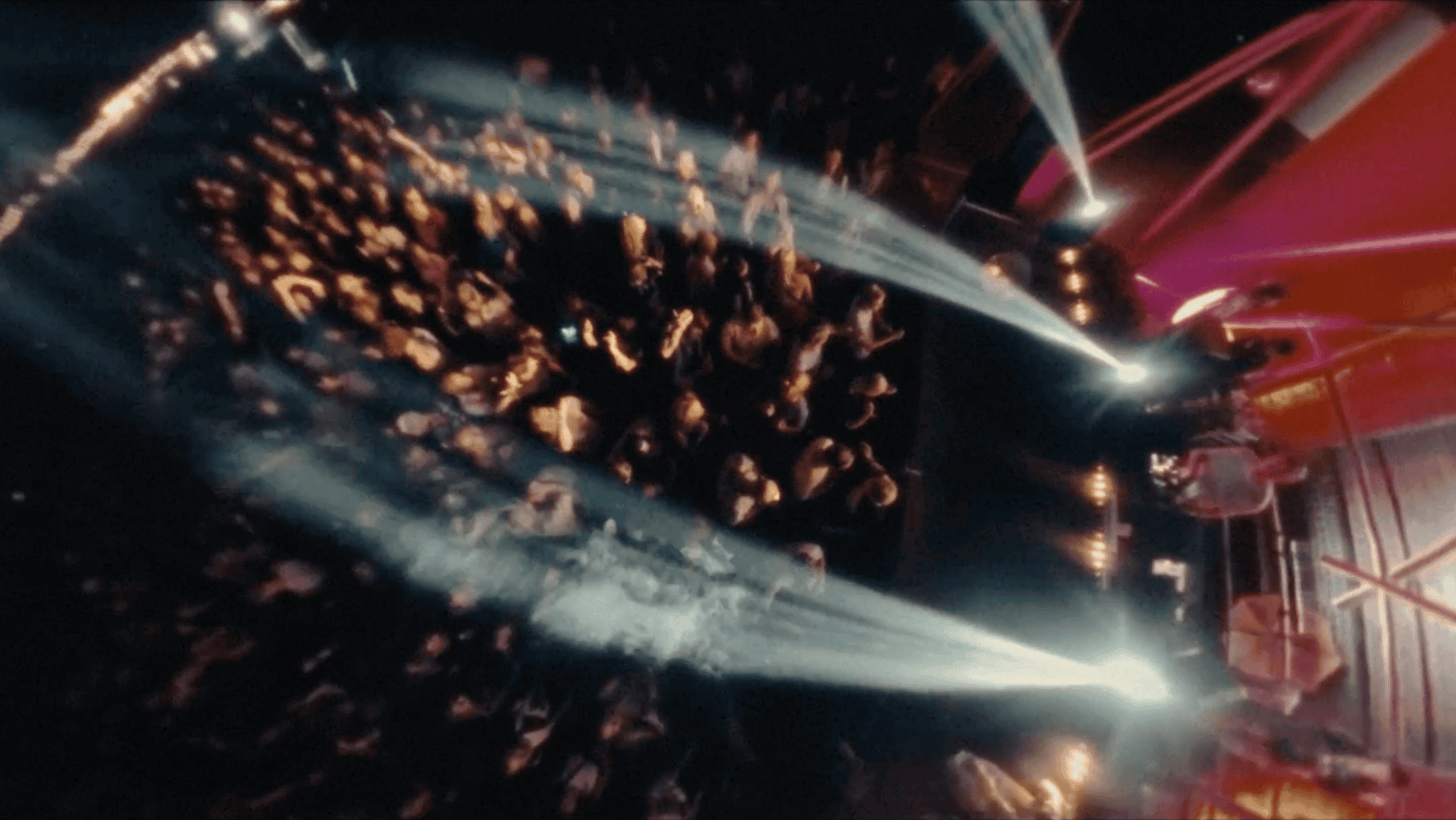 Dynamic concert scene with colorful lights and enthusiastic audience engagement.