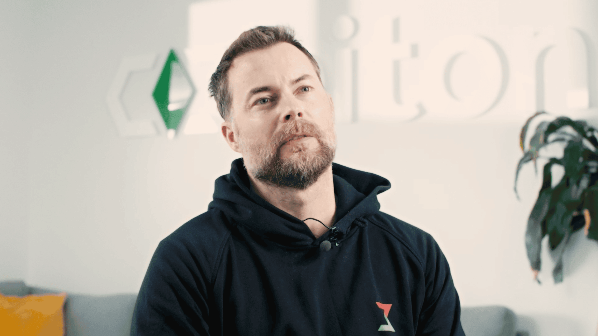 Man in casual hoodie at Waves creative video agency office.