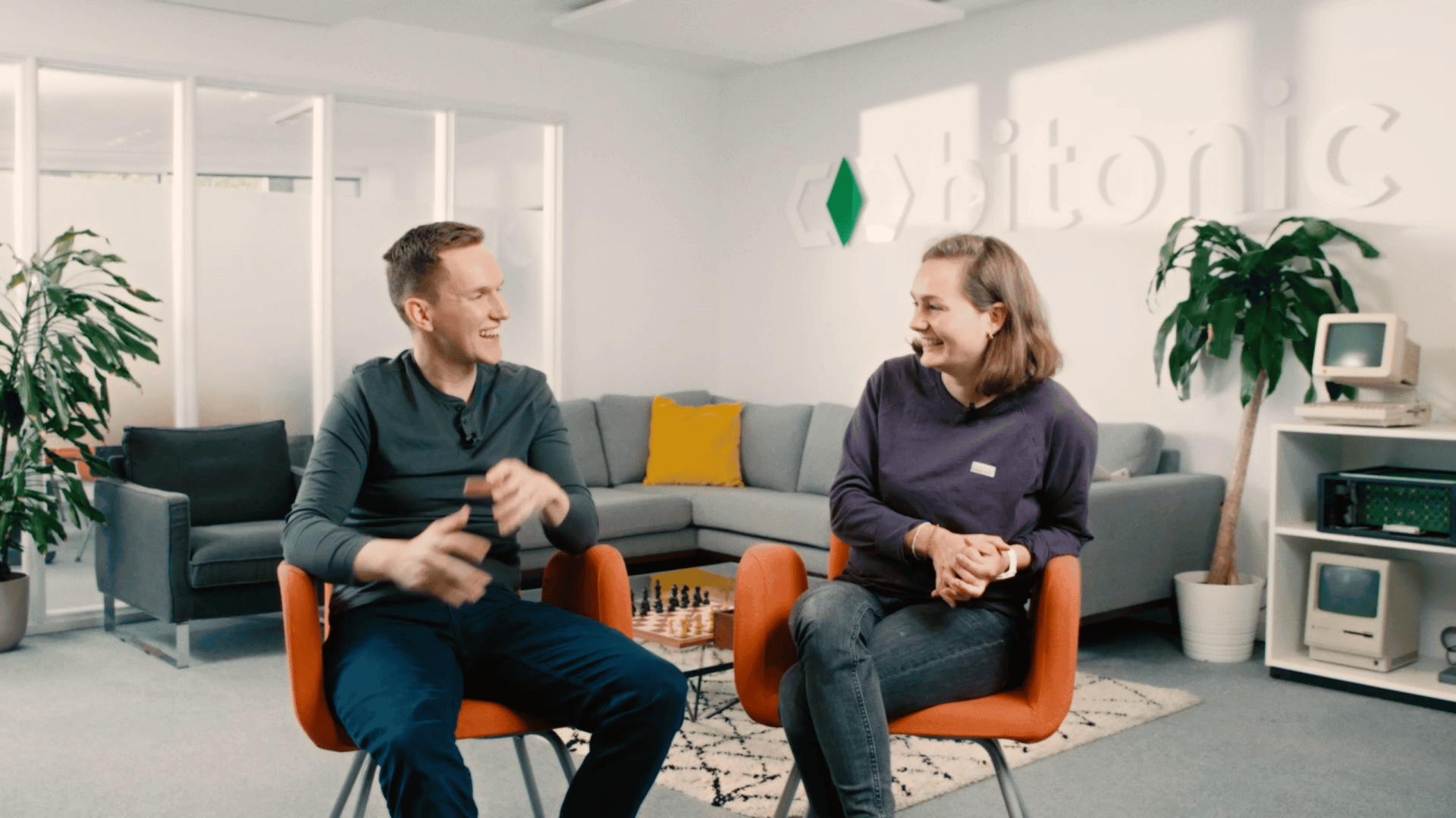 Two professionals having a creative video planning session in a modern office.