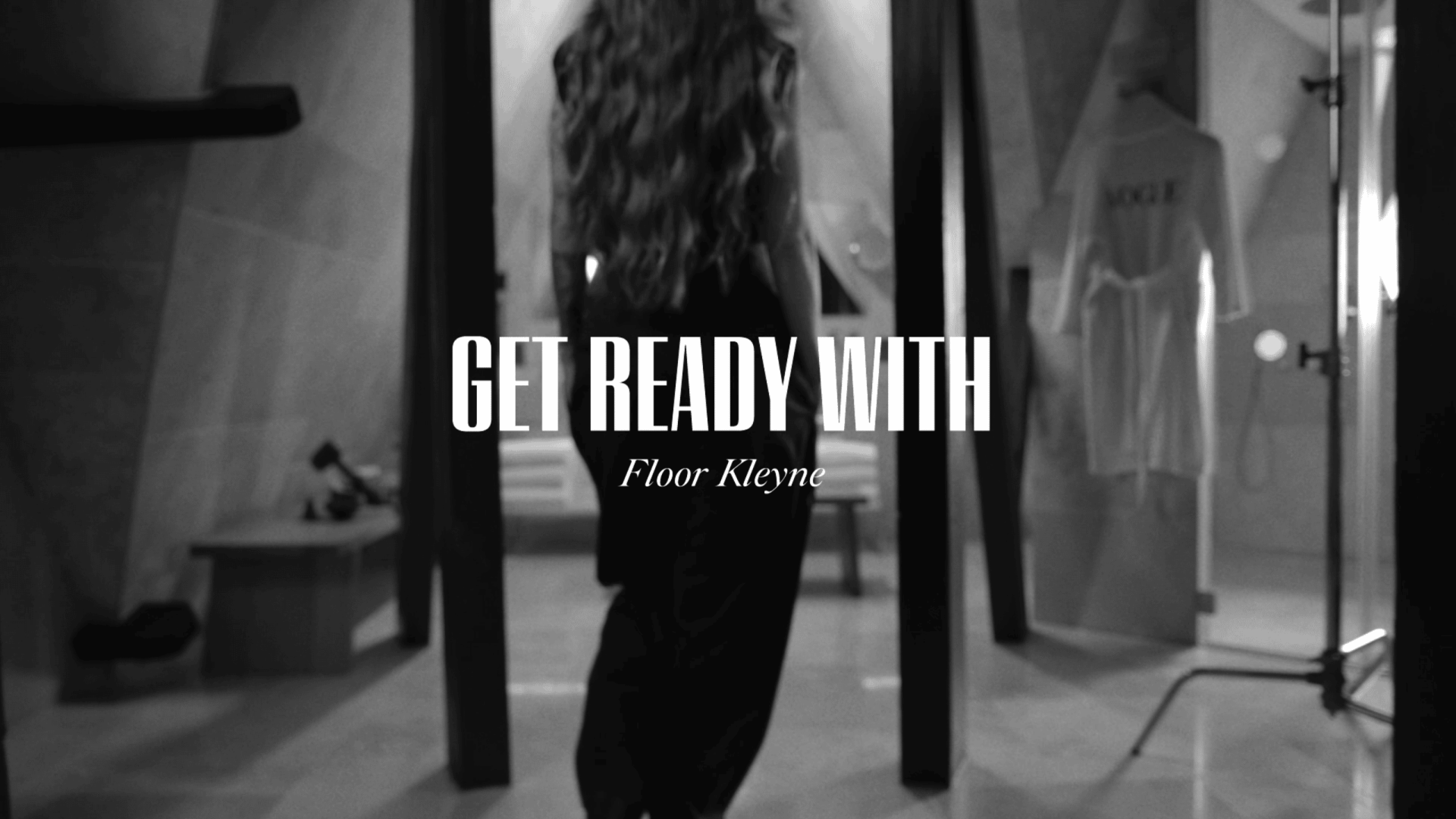 Woman preparing for a photoshoot in a modern studio setting.