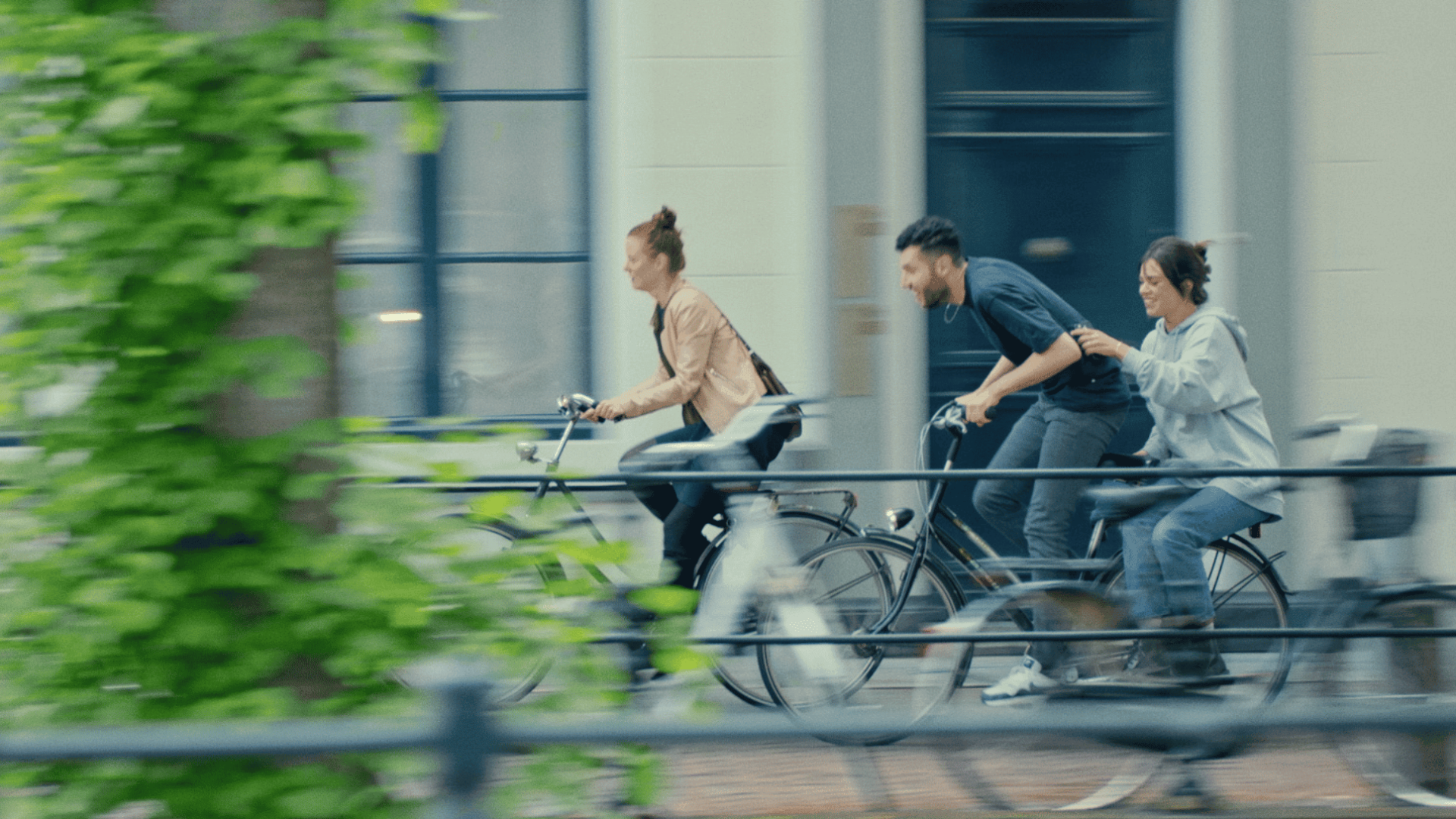 People riding bikes on city street for a creative video shoot.