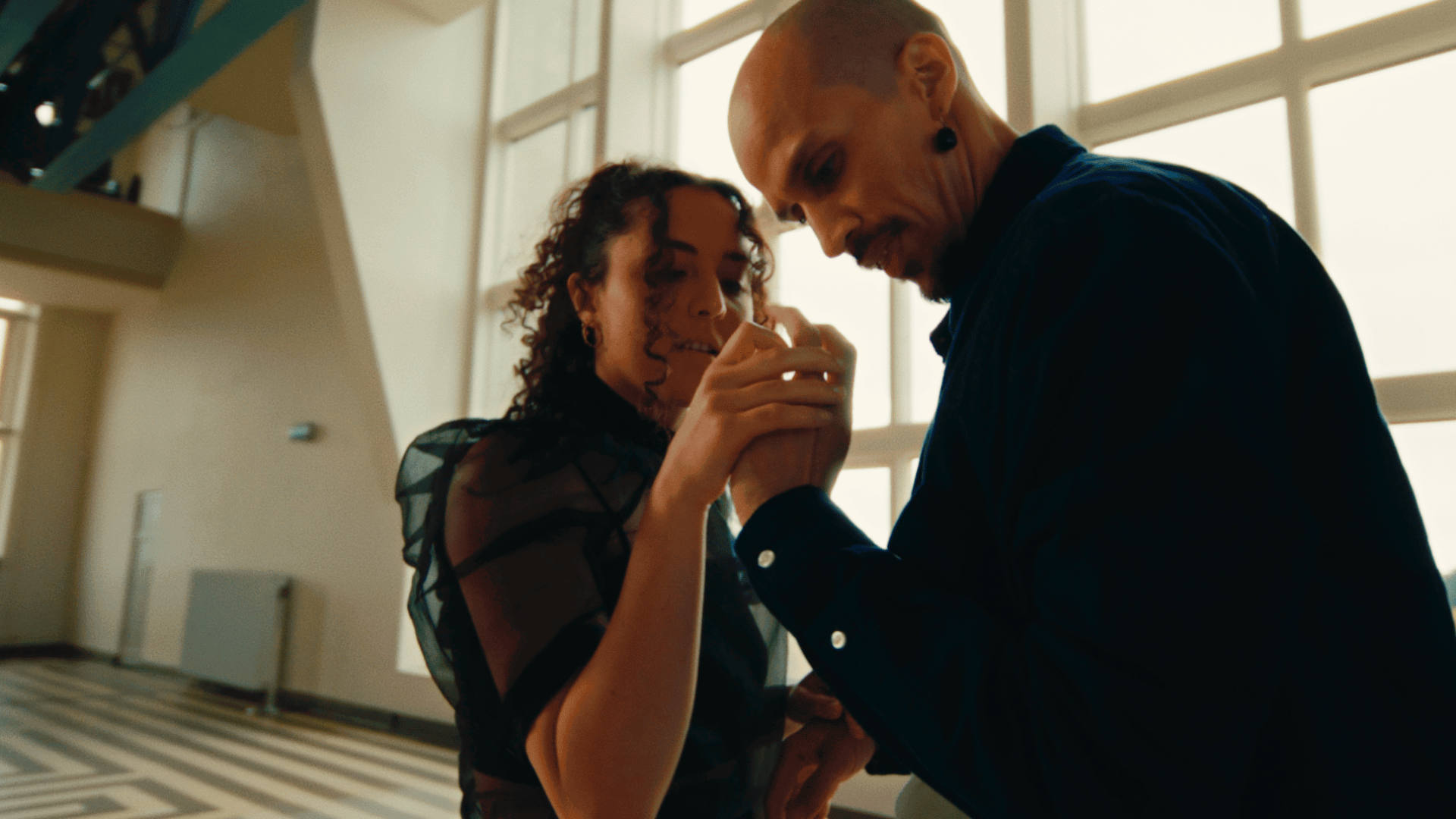 Two people collaborating on a creative project in a modern studio.