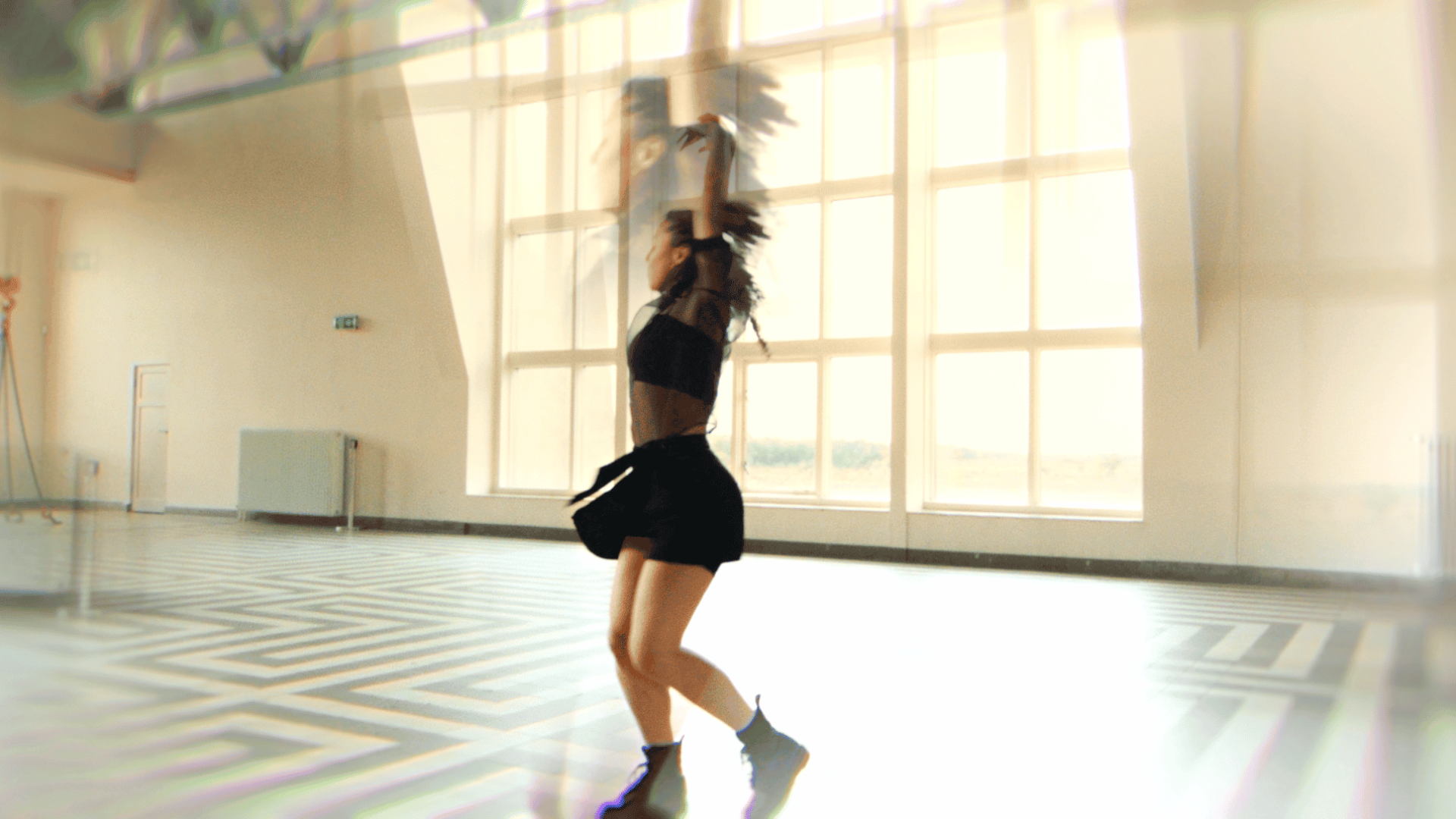 Creative dance performance in a bright studio setting.