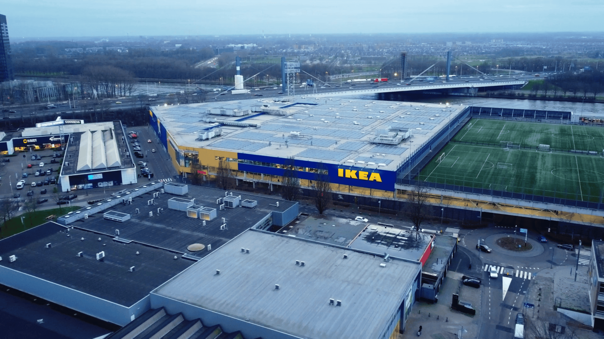 Aerial view of a large stadium with IKEA branding, parking lots, and surrounding infrastructure.