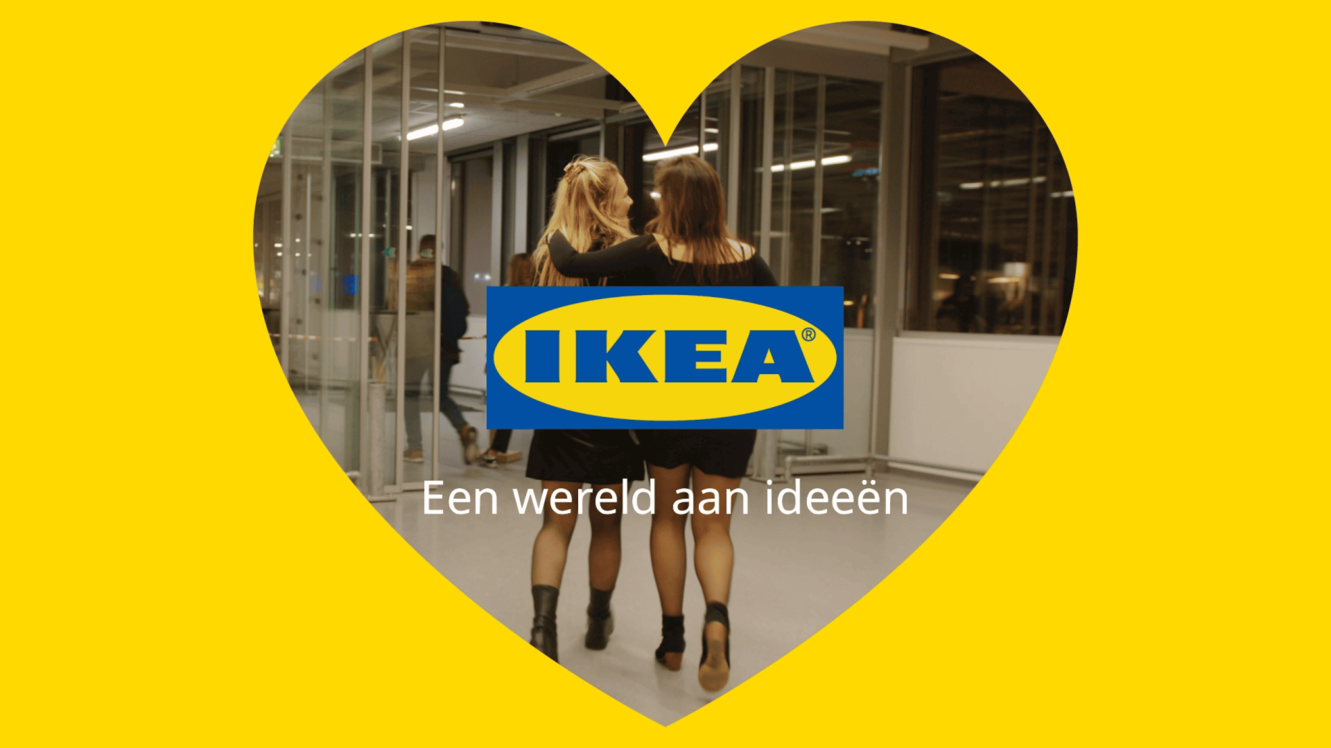 Two women walking past IKEA logo inside a heart-shaped frame, creative video content.