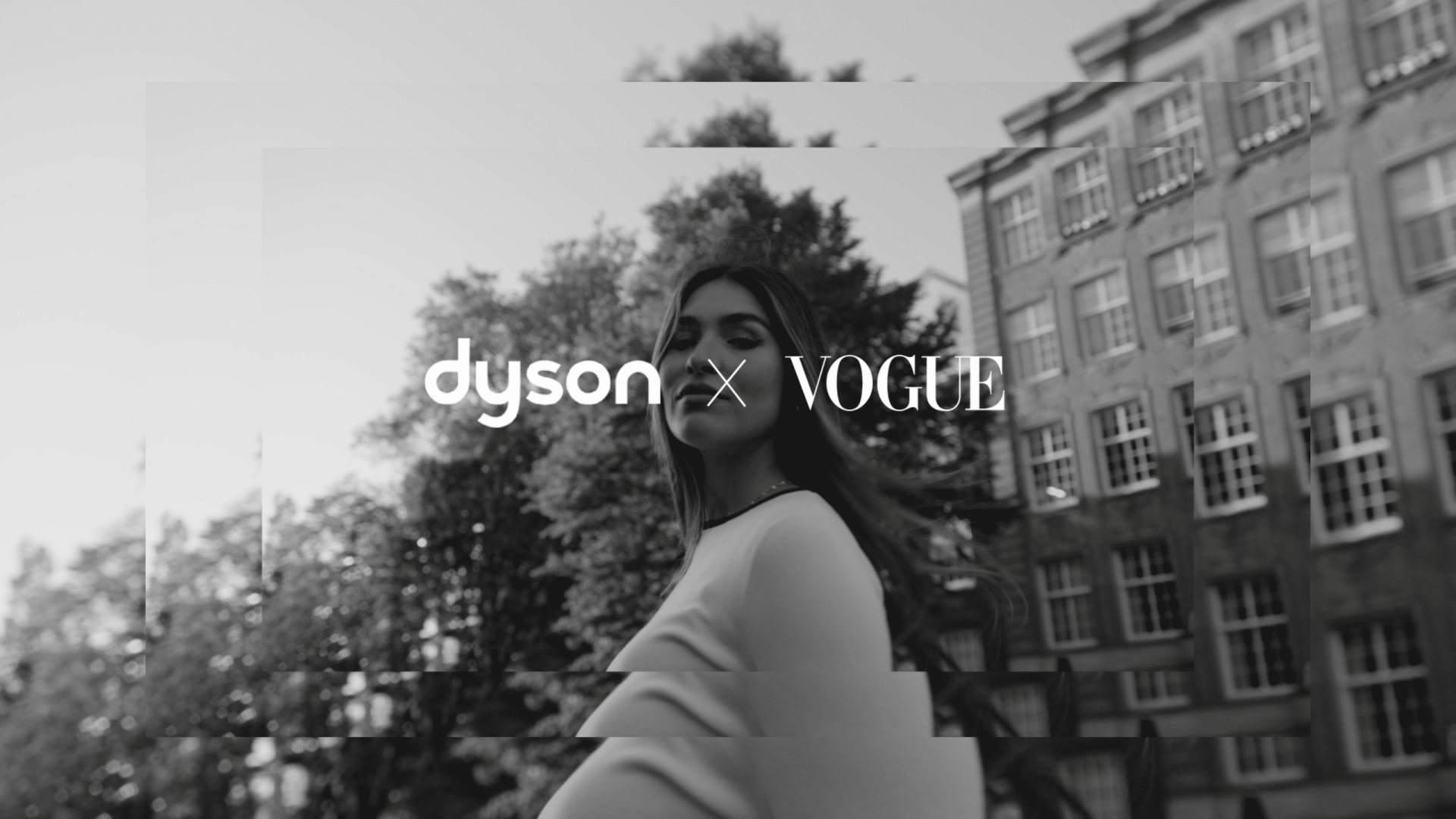 Modern woman outdoors with city buildings, representing creative video production.