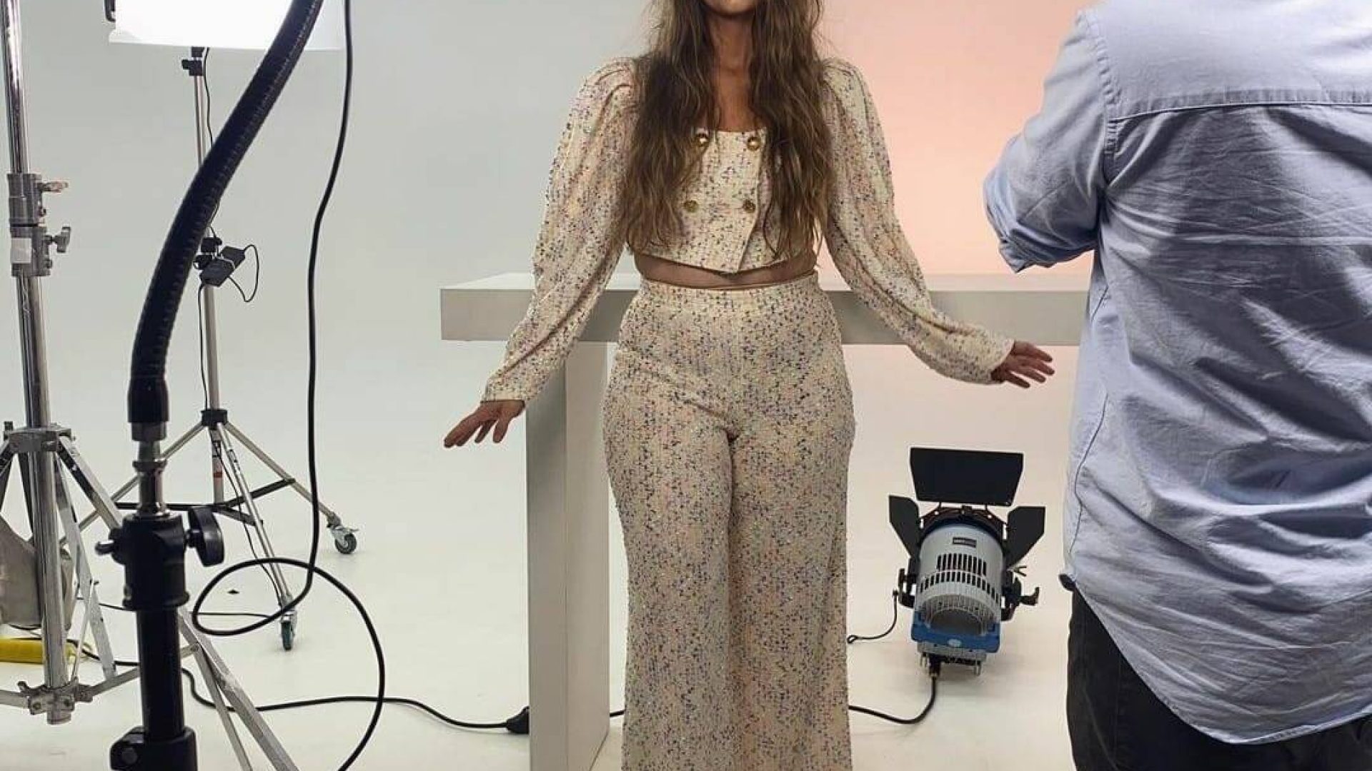 Woman in floral outfit during a professional video production.