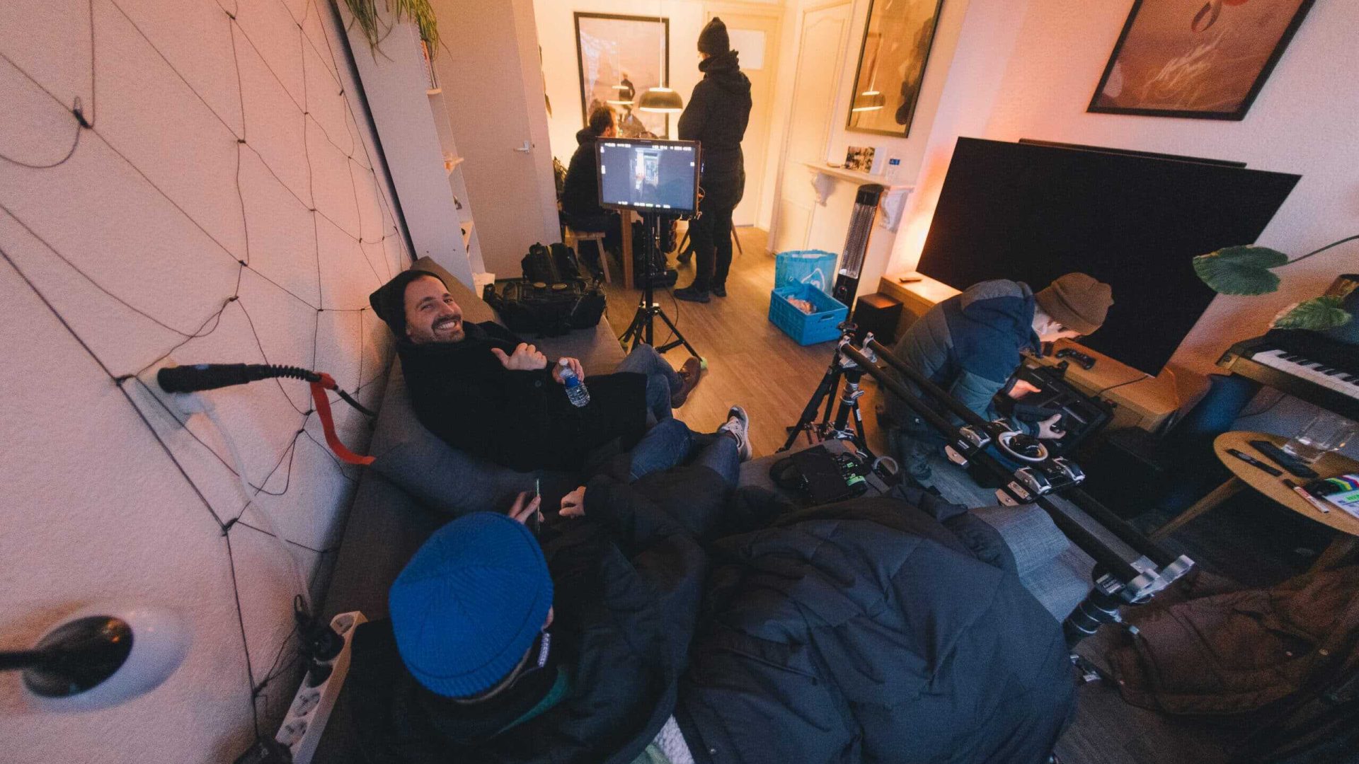 Crew filming a video scene with professional equipment and lighting.