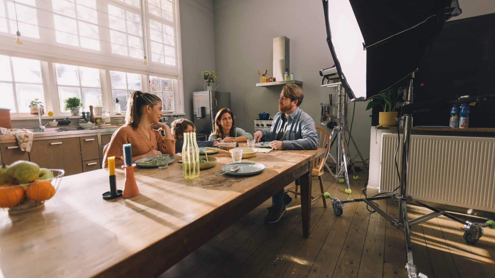 Creative video agency filming a team discussion in a well-lit studio environment.