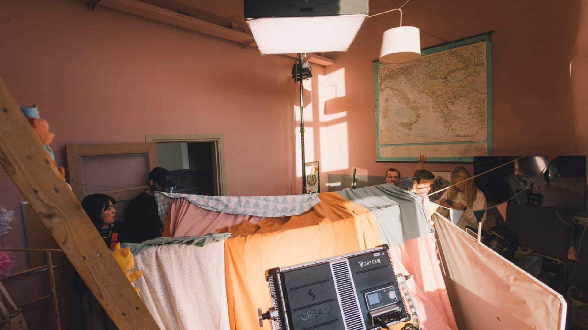 Behind-the-scenes of a creative video shoot with lighting and equipment.