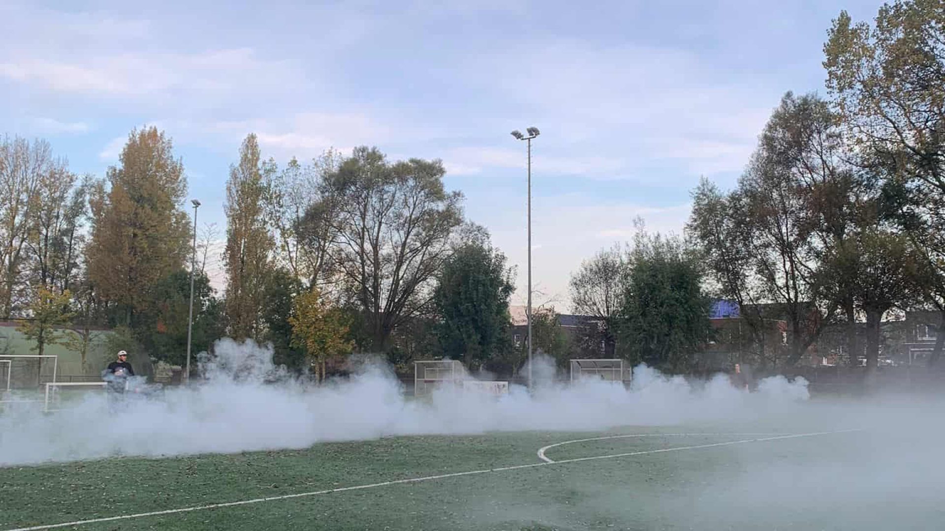 Smoke on a sports field during daytime.